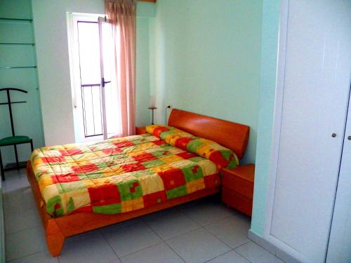 a bedroom with a bed with a colorful quilt at Valencia Port Saplaya in Port Saplaya