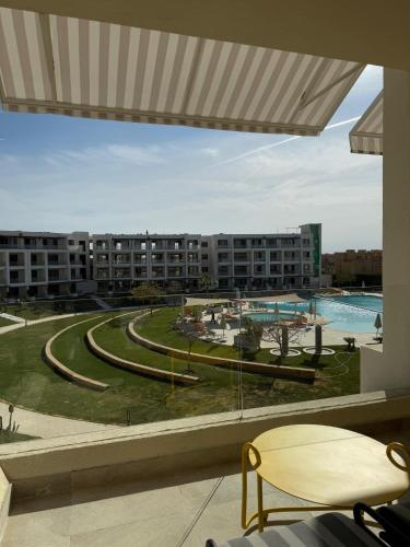 a view of a resort with a pool and buildings at The G Einbay Golf Resort in Ain Sokhna