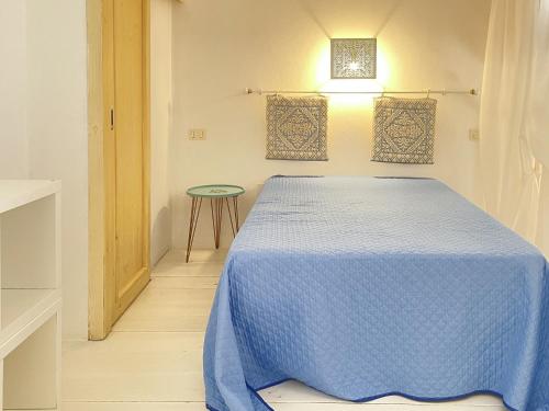 a bedroom with a blue bed and a table at CHIA HOMES in Chia