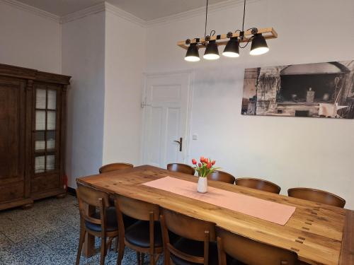 a dining room with a wooden table and chairs at Alte Schmiede in Ascheberg
