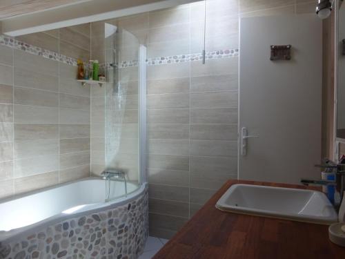 une salle de bain avec une baignoire et un lavabo dans l'établissement Landaise idéale pour 1 à 2 couples avec enfants, à Azur