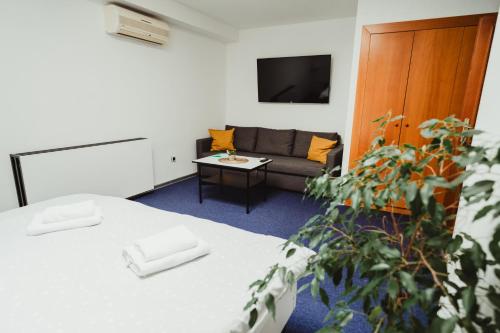 a living room with two beds and a couch at Hotel U Racka in Ostrožská Nová Ves