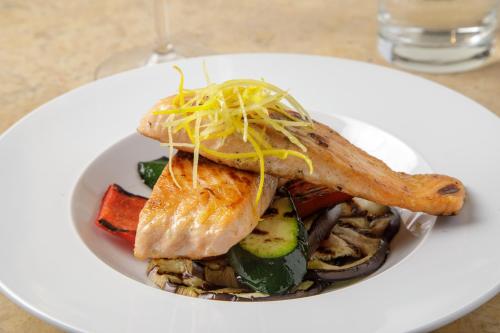 a white plate of food on a table at Donna Laura Palace by OMNIA hotels in Rome