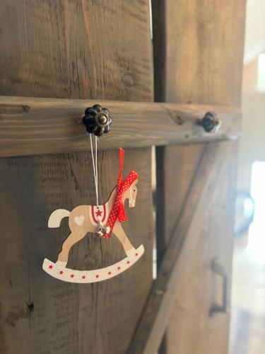 a wooden ornament of a horse hanging on a wooden drawer at Cozy studio in a horse ranch in Lieplaukė