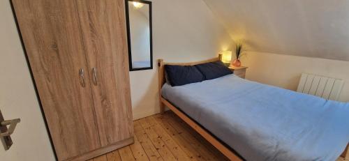 a bedroom with a bed and a wooden cabinet at Spacious Riverside 2Bd Mid City - Above Bar&Venue in Cork