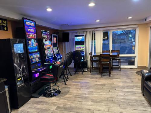 a gaming room with a table and several video games at Stay Inn by OYO Near I 80 Lincoln West in Lincoln