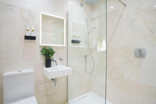 a bathroom with a shower and a toilet and a sink at Fell View Residences Modern Escape by LetMeStay in Ambleside