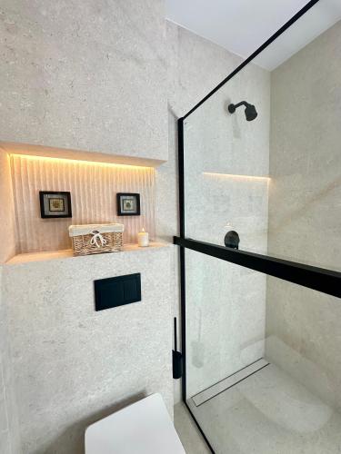a bathroom with a shower with a glass door at Pensjonat Gogol.s in Wrocław