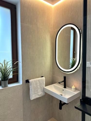 a bathroom with a sink and a mirror at Pensjonat Gogol.s in Wrocław