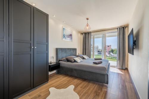 a bedroom with a bed and a large closet at Villa La Vie - Podstrana in Podstrana
