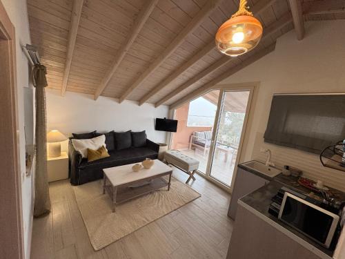 a living room with a couch and a table at Deluxe Dina in Skala Potamias