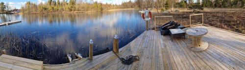 a wooden dock on a body of water at Sjöviksvilla Sjöviksvägen in Växjö