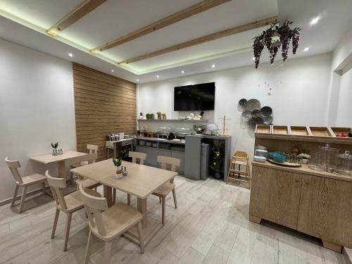 a large kitchen with two tables and a counter at Deluxe Dina in Skala Potamias