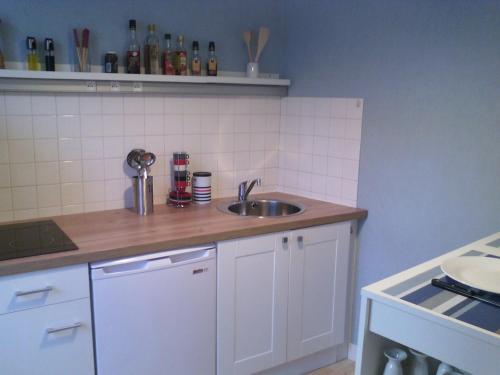 a kitchen with a sink and a counter top at T1 lumineux, Saint Malo-Solidor, parking gratuit in Saint Malo