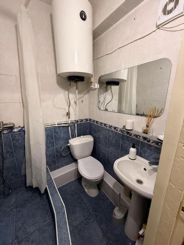 a bathroom with a toilet and a sink at One Room Apartment in Chişinău