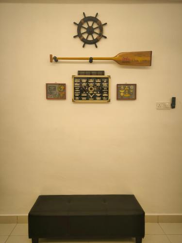 a room with a bench and a wooden steering wheel on a wall at HV SENCHO HOMESTAY House Vessel Sencho Home of Nautical Decoration in Temerloh