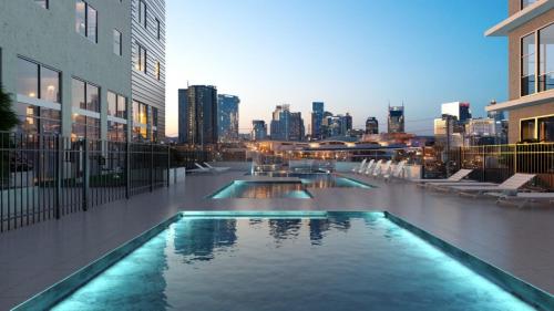 a swimming pool with a city skyline in the background at The Gulch Music Row Broadway Nashville Parking in Nashville