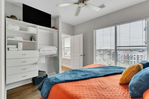 a bedroom with a bed and a large window at The Gulch Music Row Broadway Nashville Parking in Nashville