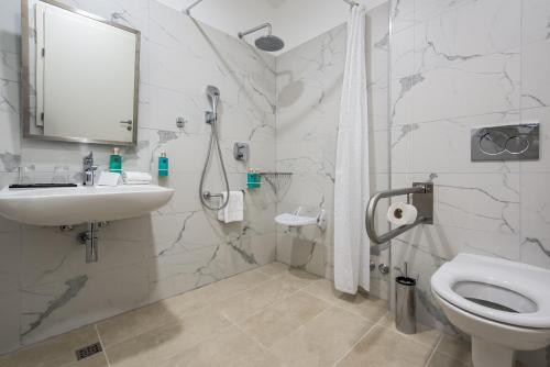 a bathroom with a toilet and a sink and a shower at Boutique Hotel Esplanade - Adults only in Crikvenica