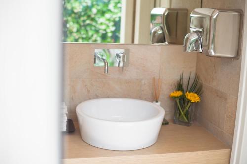 a bathroom with a white sink and a mirror at Hotel Elite in Lido di Jesolo