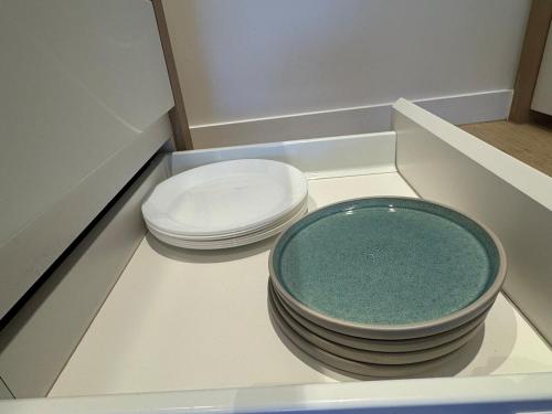 two stacks of bowls sitting on top of a counter at Box Hill luxury 29th floor apartment with car park in Box Hill