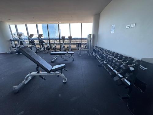 a gym with rows of chairs and tread machines at Box Hill luxury 29th floor apartment with car park in Box Hill