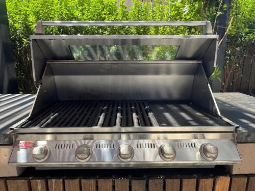 a grill sitting on top of a patio at Box Hill luxury 29th floor apartment with car park in Box Hill