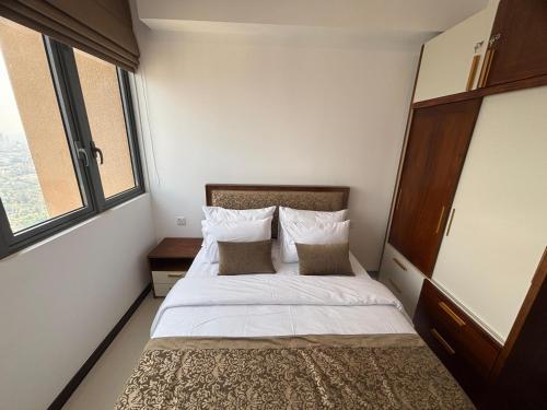 a bedroom with a bed and two windows at Colombo, Trizen Luxury Apartments, Sri Lanka in Colombo