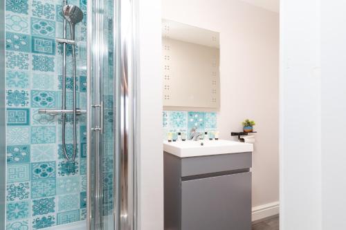 a bathroom with a sink and a shower at The Clarence Gardens Hotel, BW Signature Collection in Scarborough