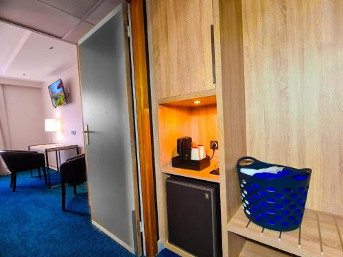 a hotel room with a desk and a chair at Best Western Plus Hotel & SPA Le Schoenenbourg in Riquewihr