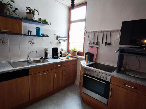 a kitchen with a sink and a stove top oven at FeWo Wittstock in Wittstock