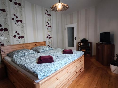 a bedroom with a large wooden bed with purple blankets at FeWo Wittstock in Wittstock