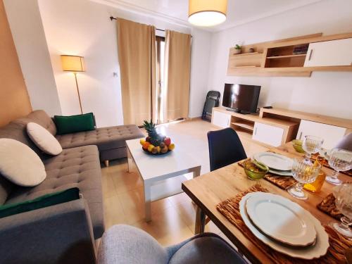 a living room with a couch and a table at PosadaLux Carmen 4Pax in Santa Pola