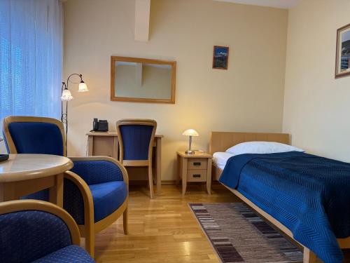 Postel nebo postele na pokoji v ubytování Hotel Uniwersytecki