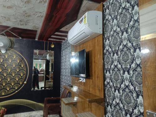 a room with a mirror and a hair dryer on the wall at Tejas dream house 4 minute away from Golden Temple in Amritsar