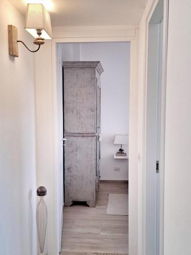 a hallway with a door in a white room at Le Mimose Terrace in Bordighera