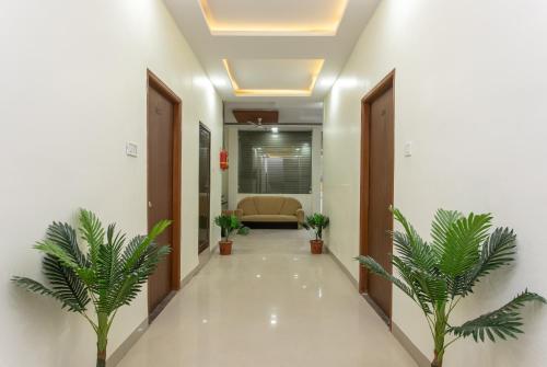 a corridor of a hospital with plants in a hallway at Hotel O Manjulam Regency in Indore