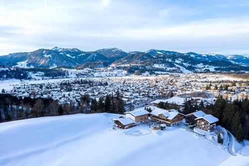 an aerial view of a resort in the snow at Hotel Kühberg in Oberstdorf