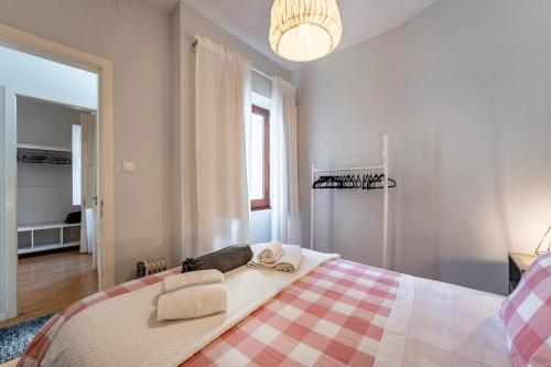a bedroom with a bed with two towels on it at Casa da Foz in Porto