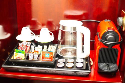 a counter with a coffee maker and a blender at Lancaster Kumasi City in Kumasi