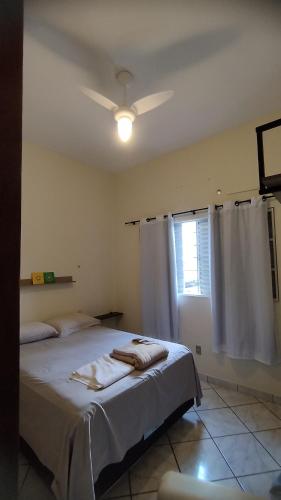 a bedroom with a bed and a ceiling fan at Sobrado para ate 8 pessoas in Barra do Garças