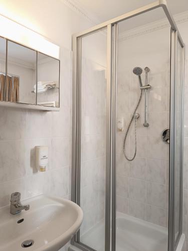 a bathroom with a shower and a sink at Antonappartements in Dresden