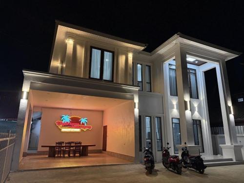 a building with motorcycles parked in front of it at night at Utopia house-luang prabang琅勃拉邦乌托邦庭院 in Luang Prabang