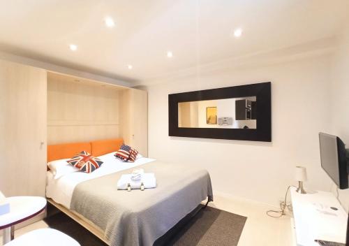 a hotel room with two beds and a television at Viva Riviera - 19 rue des Frères Pradignac in Cannes
