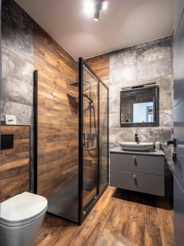 a bathroom with a shower and a toilet and a sink at Casa Dea in Malinska