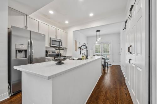 a kitchen with a large white counter and a refrigerator at Perfect In-Town location! KINGbed, BBQ and Parking in Atlanta