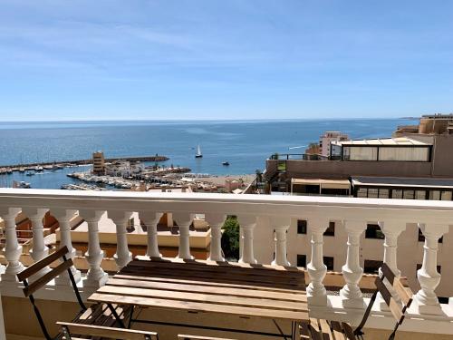 a balcony with a bench overlooking the ocean at Panoramic Sea Views with Balcony, Air Conditioning and Parking in Aguadulce