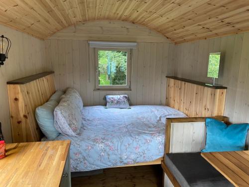 a bedroom with a bed in a small room at Glamping at Holly Grove Farm in Stoke on Trent