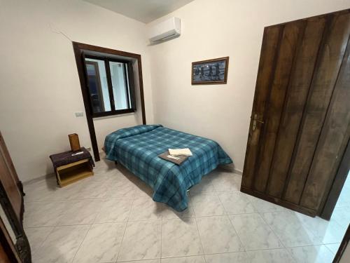 a bedroom with a bed and a wooden door at Azienda agricola zootecnica Soriente di Guglielmo Areh Soriente & C.S.A.S in Roccapiemonte
