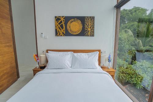 Ένα ή περισσότερα κρεβάτια σε δωμάτιο στο The Cove Bali